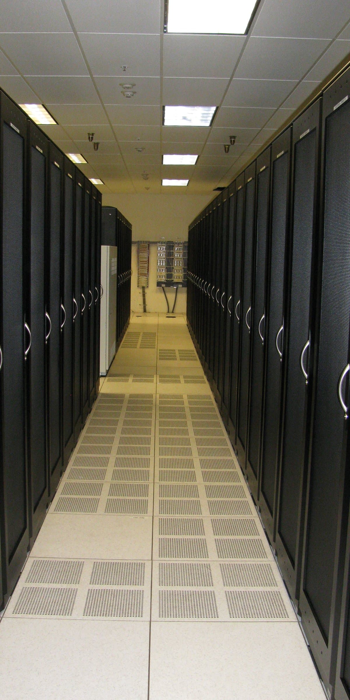Representative photograph of a cabinet aisle in a data center.